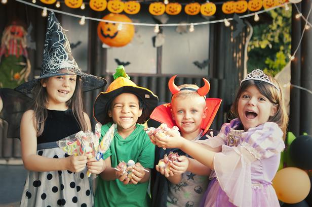 Kids holding Halloween candy