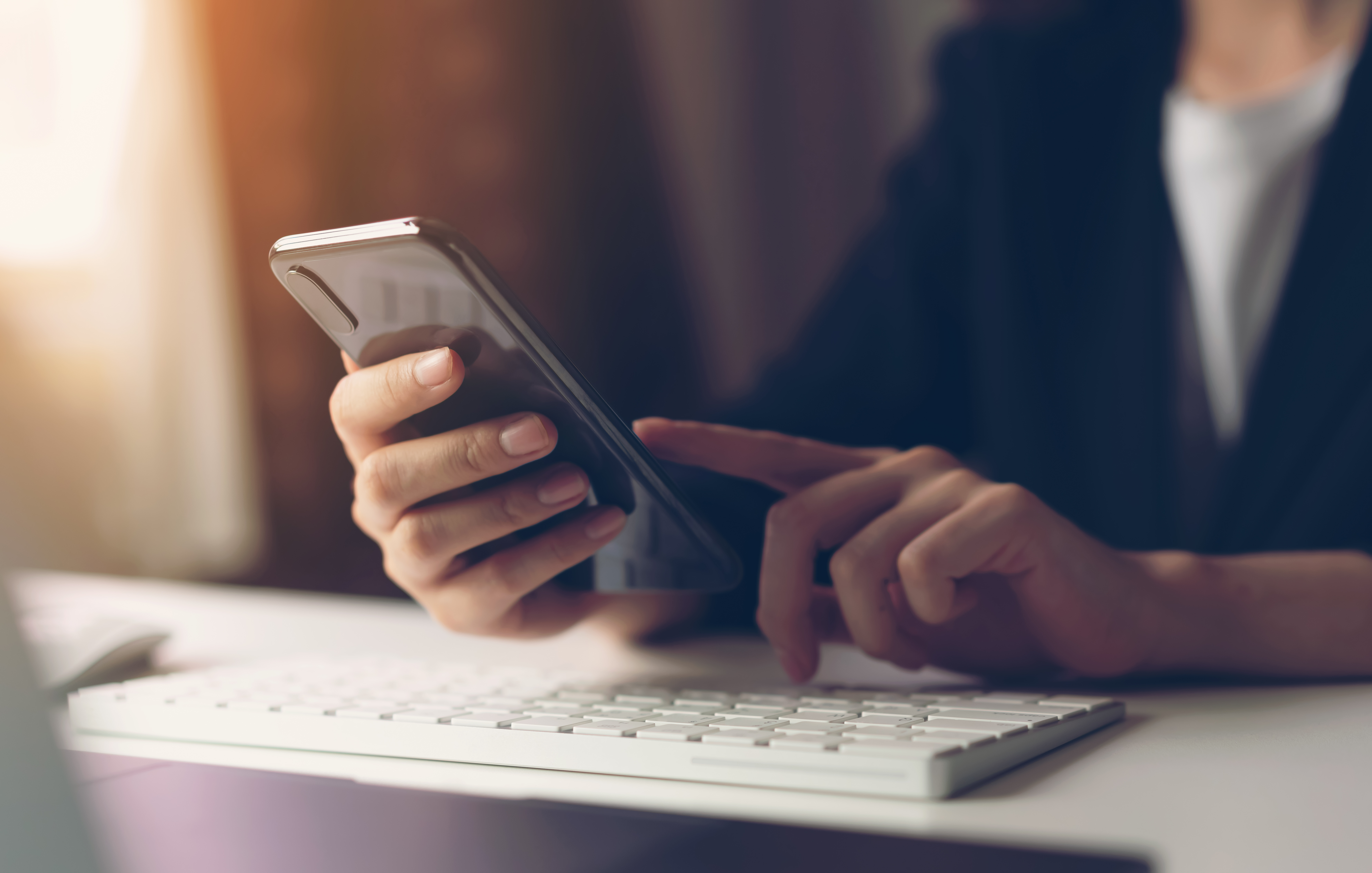 GettyImages-1134890323 Person scrolling through cell phone